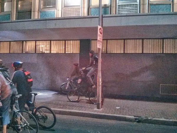 tall bike holding onto lamp post